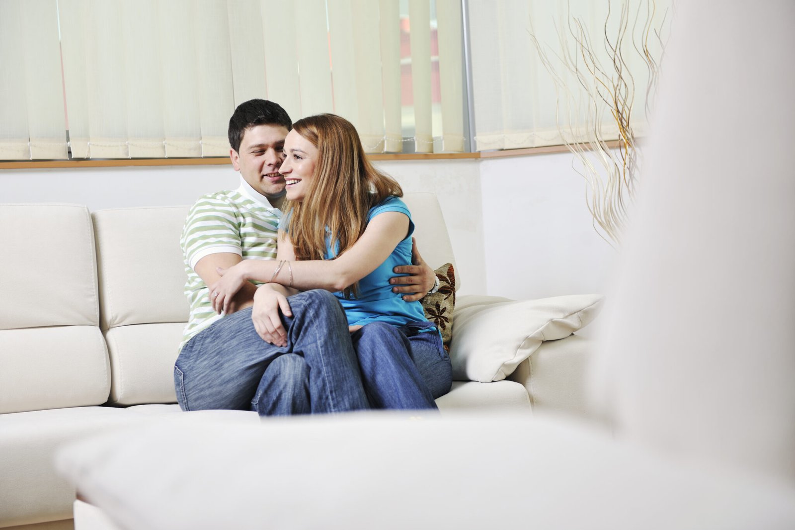 happy young couple relax at home in modern and bright living room