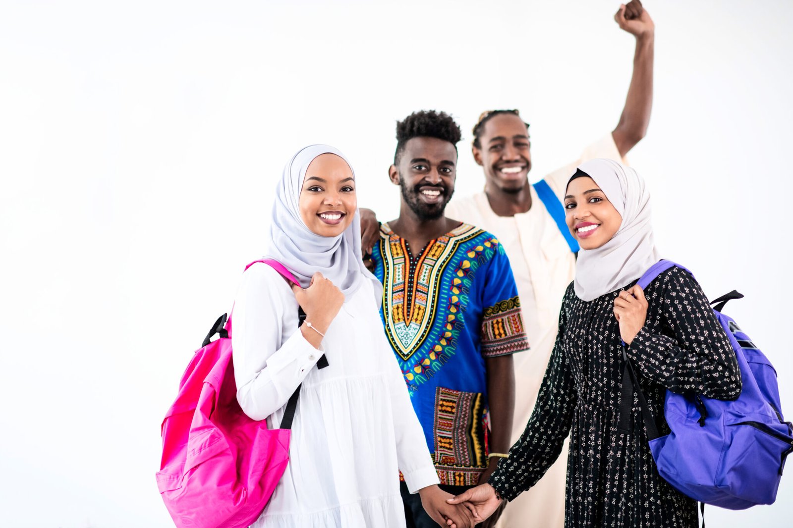 group portrait  of happy african students standing together against white background girls wearing traidiional sudan muslim hijab fashion